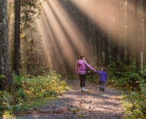Mother and Daughter walking through the forest