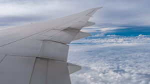 Aircraft wing above clouds during flight